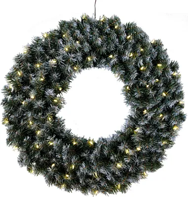 A green Christmas wreath with white snow decor and yellow lights, isolated on a white background.