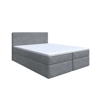 A studio shot of a gray bed with a white mattress and topper, against a white background.
