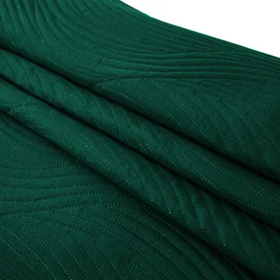 A folded green blanket with a textured pattern.