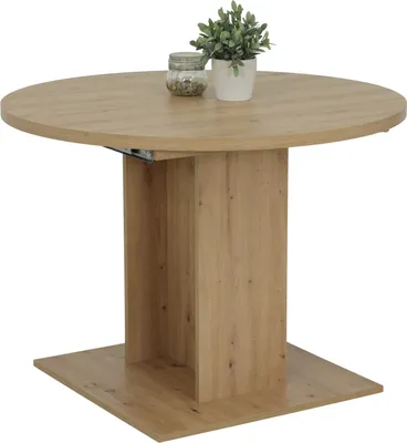 A round dining table with a wooden finish and a pedestal base, shown against a white background. A small potted plant and a decorative jar are placed on the table.