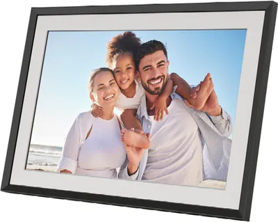 A digital photo frame displaying a family on a beach.