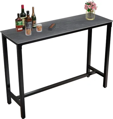 A bar table with bottles of alcohol and glasses on it.