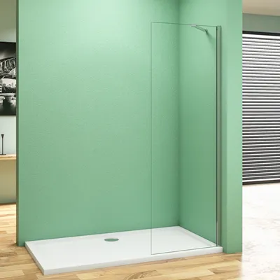 A walk-in shower enclosure with a glass panel and a white shower tray, set against a light green wall and a wooden floor.