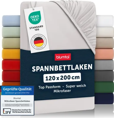 A light gray fitted sheet is shown, with a tag attached and a stack of other colored sheets to the left and right.