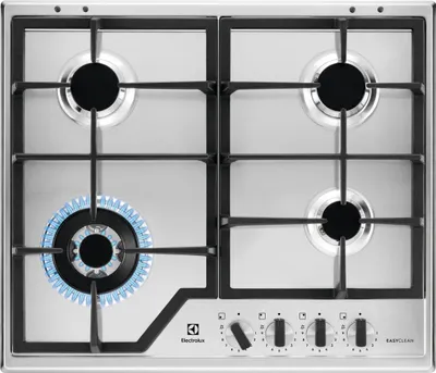 A top-down view of a gas stove with one burner lit.