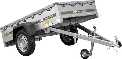 A silver utility trailer with a grey tarp cover, shown from a three-quarter side view against a white background.