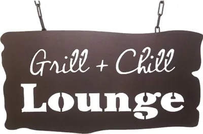 A dark brown metal sign with white text, hanging from chains.