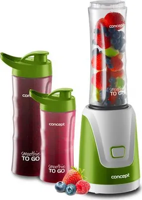 A blender with two smoothie cups and some berries.