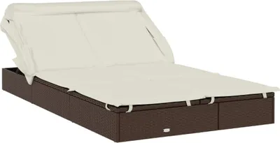 A brown poly rattan sun lounger with a cream canopy and cushions, shown from a side-diagonal angle on a white background.