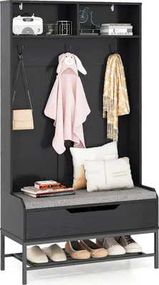 A dark gray hall tree with a bench and shoe rack, featuring various items like bags, coats, and pillows.
