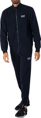 A man wearing a blue EA7 tracksuit.