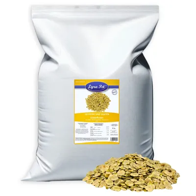 A large white bag of pet food with a label and a pile of the product in front of it.