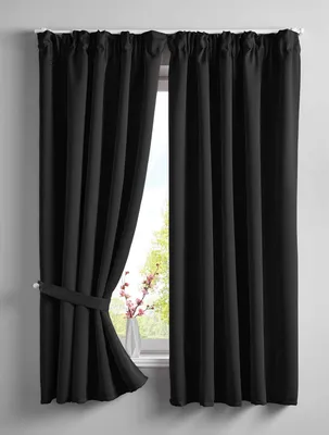 Two black curtains are shown, one of which is tied back with a fabric tie.