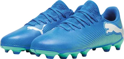 A pair of blue Puma soccer cleats with green accents on the soles.