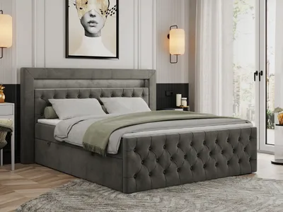 A bedroom scene featuring a large, upholstered bed.