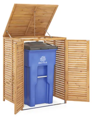 A wooden trash can enclosure with a blue trash can inside.