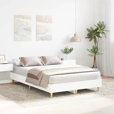 A bedroom scene with a white bed.