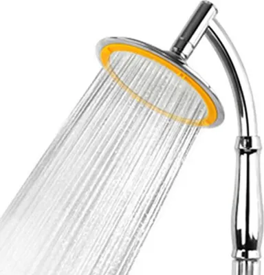 A close-up shot of a shower head with water spraying from it.