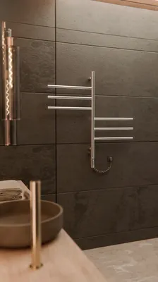 A modern bathroom setting with a wall-mounted towel warmer and a sink.