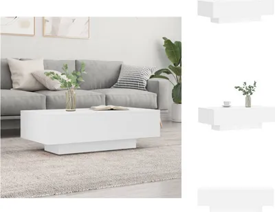 A white coffee table is placed in front of a gray sofa in a living room.