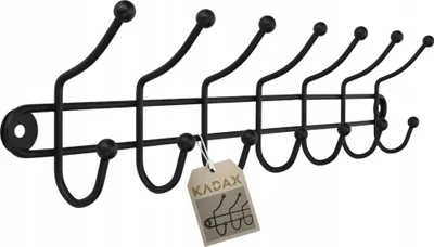 A black metal coat rack with seven hooks is shown against a white background. A small, light brown tag with the brand name 'KADAX' and an illustration of hooks is attached to one of the hooks.