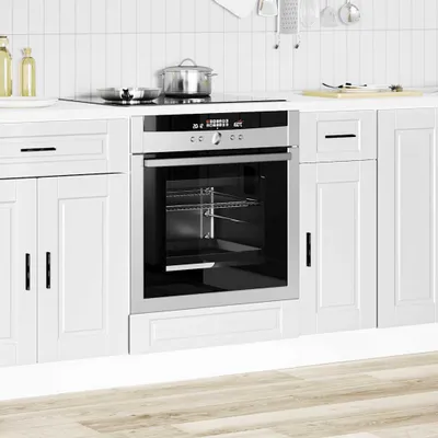A modern kitchen scene with white cabinets and a built-in oven.