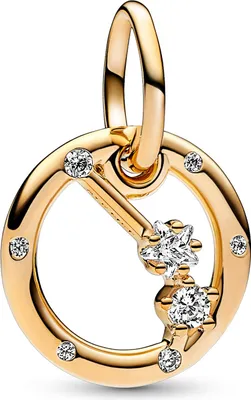 A close-up studio shot of a gold-colored charm with clear stones.