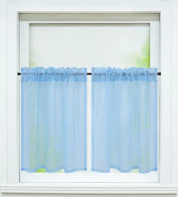 A close-up view of a window with light blue sheer curtains.