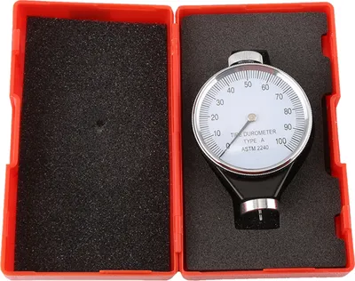 A durometer is shown inside its red case, which is open.