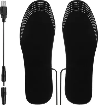 A pair of black heated insoles with a USB charging cable and adapter.