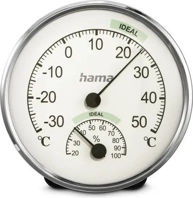 A close-up of an analog thermometer and hygrometer.