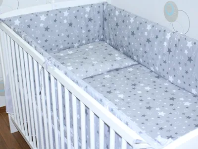 A baby crib with bedding.