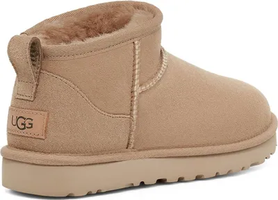 A side view of a beige UGG boot.