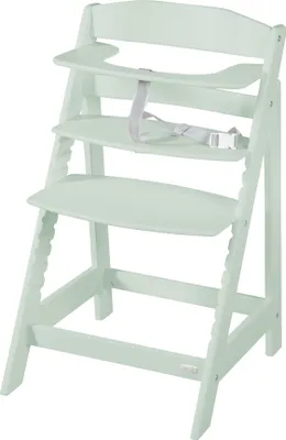 A mint green wooden high chair with a safety harness.