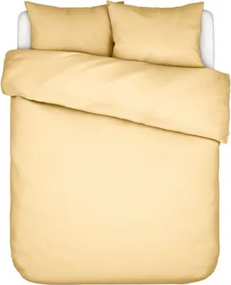A top-down view of a yellow duvet and two pillows on a bed.