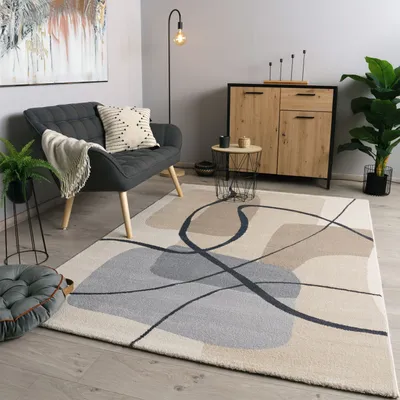 A modern living room with a sofa, rug, cabinet, and plants.