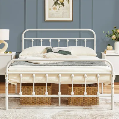 A white metal bed frame is shown in a bedroom setting with a blue wall and bedside tables.