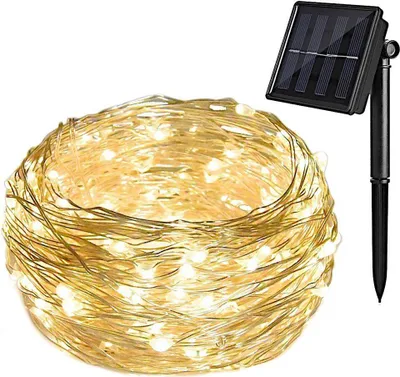 A coiled string of solar-powered LED lights with a solar panel on a stake.