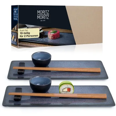 A sushi set for two people, including plates, bowls, and chopsticks, displayed with a product box in the background.