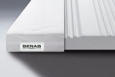 A close-up view of a mattress topper, showing its layered construction and texture.