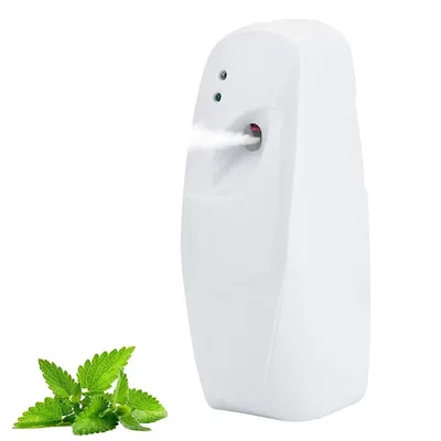 A white automatic air freshener dispenser is shown spraying a mist, with a sprig of green mint leaves in the foreground.