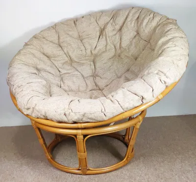 A papasan chair with a large cushion is shown against a plain background.