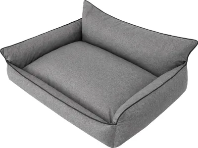 A grey dog bed with raised sides and a cushion.