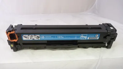 A toner cartridge is placed on a white surface against a white background.