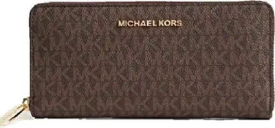A brown Michael Kors wallet with a monogram pattern.