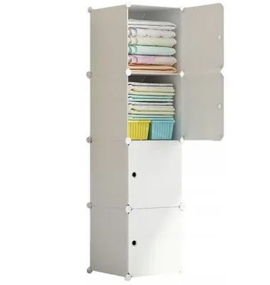 A white modular closet with doors open, showing folded clothes and baskets inside.