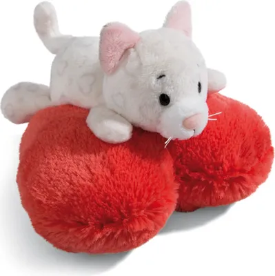 A white plush cat with pink ears lies on two red plush hearts.
