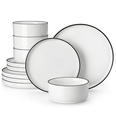 A set of white ceramic plates and bowls with black trim, neatly arranged against a white background.
