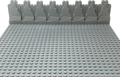 A LEGO baseplate with a grey rock wall built on top.