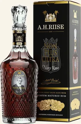 A bottle of A.H. Riise Non Plus Ultra Very Rare rum and its accompanying box are displayed against a white background.
